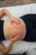 Person relaxing in a minimalist wellness studio with soft ambient lighting and organic textures
