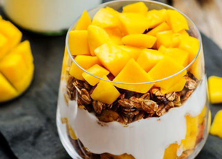 Glass mason jar granola overnight oats yoghurt parfait mango turmeric
