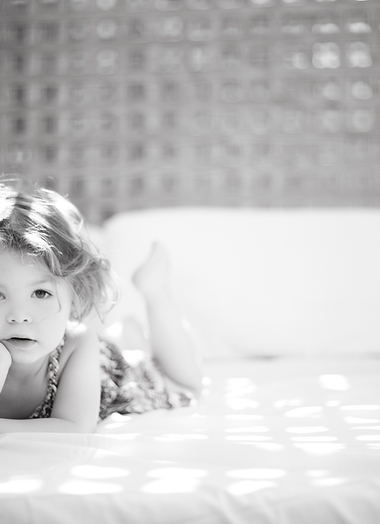 A young dhild on a bed