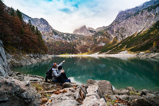 A couple traveling around a lake