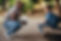 School teacher motivating a young primary school kid outside class. Child mentor talking t