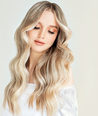 Beautiful girl with hair coloring in ultra blond. Stylish hairstyle curls done in a beauty