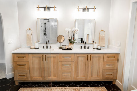 a bathroom with two sinks and two mirrors