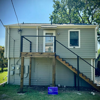 New black steel exterior staircase and landing on a gray two-story house – Good Deal Builder, Dallas TX