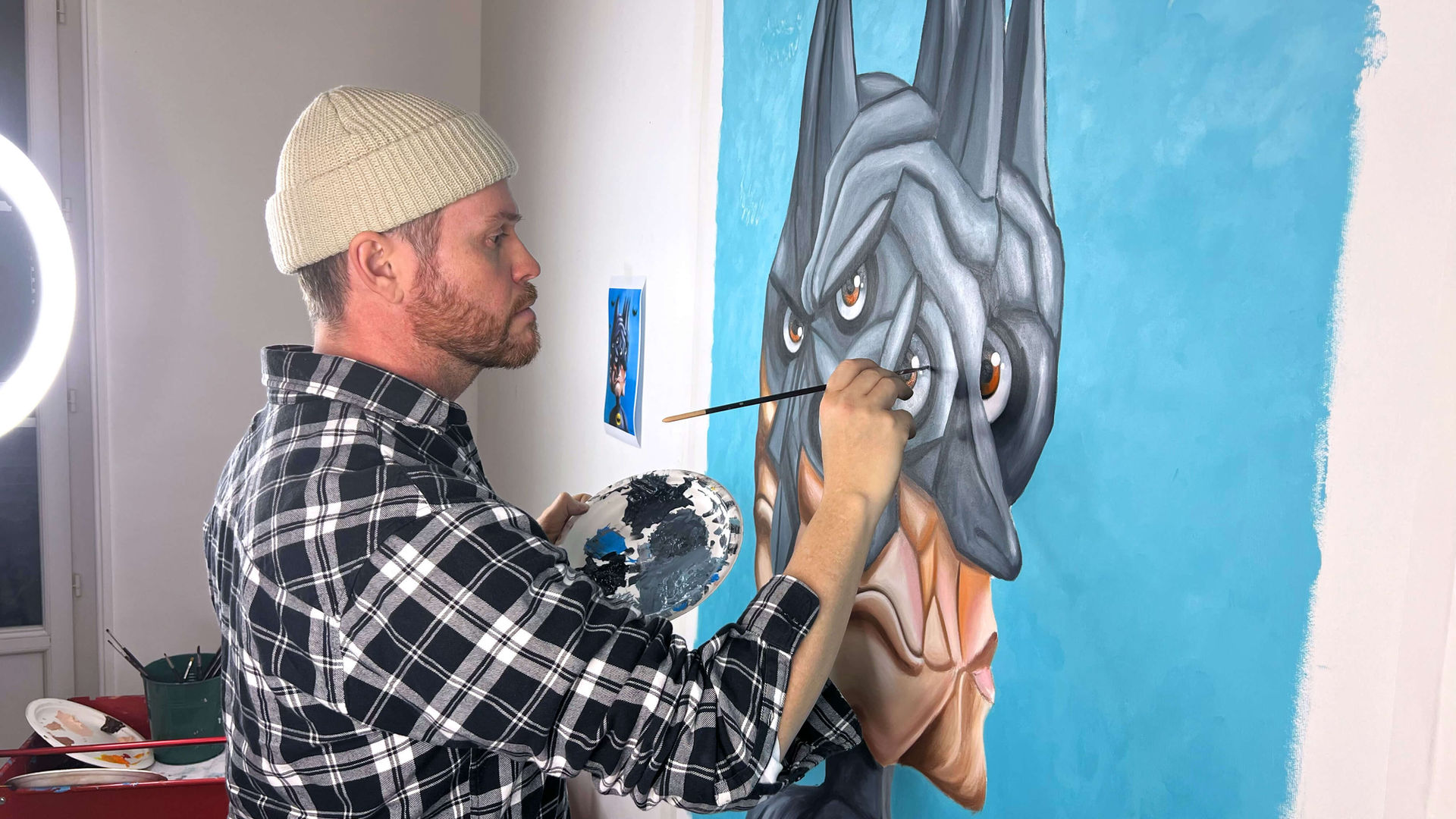 Mr. Pinkbrush working on Batman Behind the Mask painting in studio, contemporary fragmented cubism artwork process