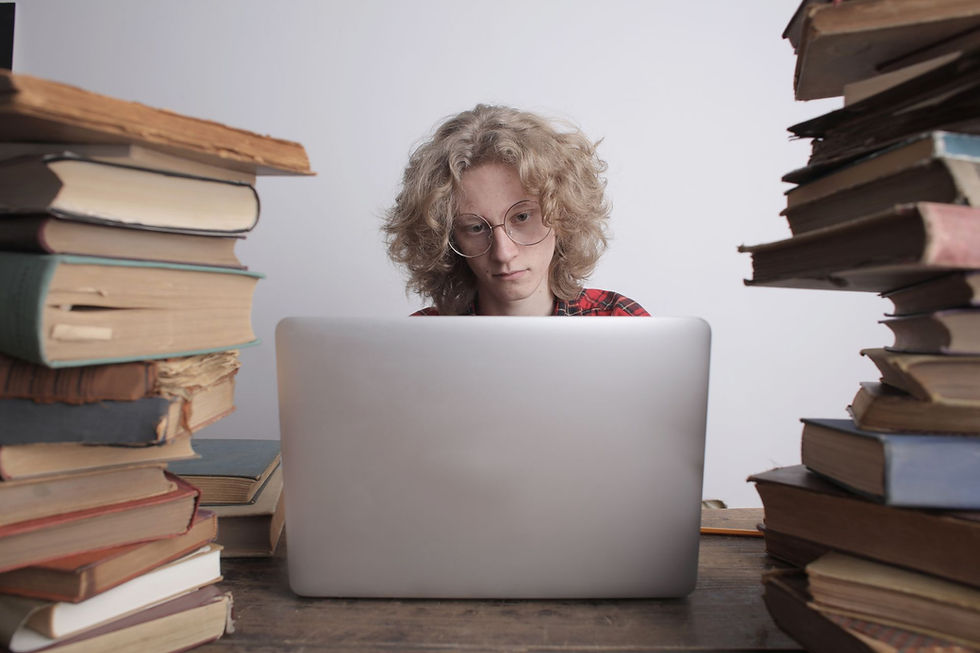 Student studying with a laptop and books