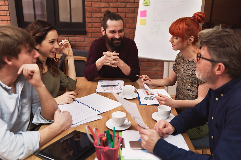 Colleagues discussing onboarding plans around a meeting table