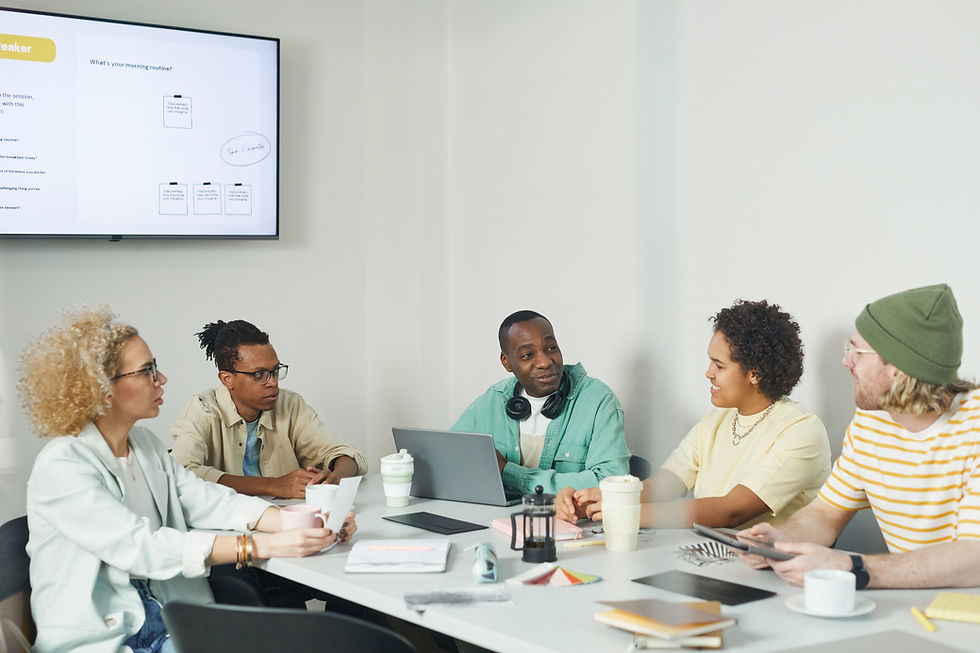 Colleagues discussing ideas around a meeting table in an office