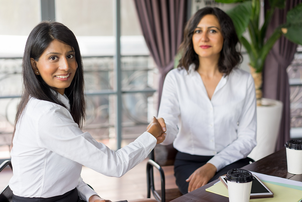 Colleagues welcoming a new team member with a handshake