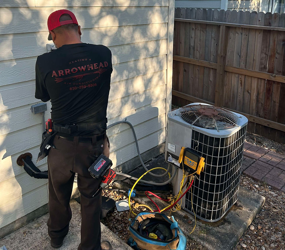 High angle view of a technician inspecting an air conditioning unit
