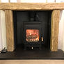 fireplace with caithness flagstone hearth, wood burning stove and wooden surround and mantle