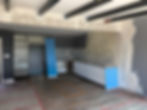 Interior space under renovation with unfinished surfaces prior to modern interior transformation in Los Angeles