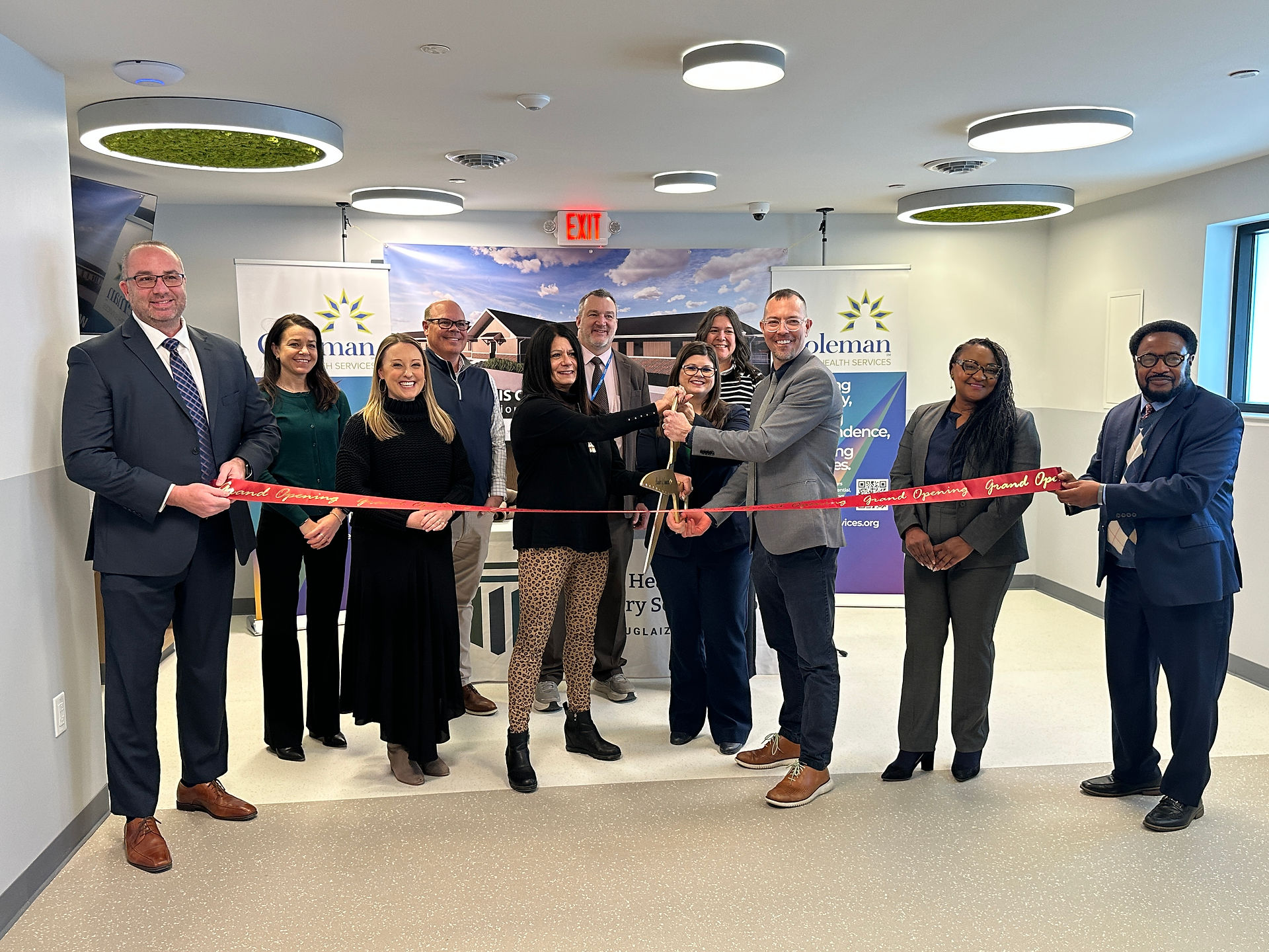 Group cutting ribbon inside Crisis Stabilization Unit