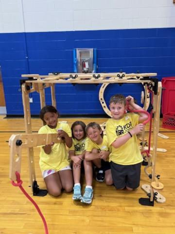2nd Grade campers posing with their creation made in the Mobile Factory