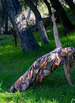 Rachel Plonka, holistic nurse coach and founder of The Coherence Studio, practicing yoga in the forest.