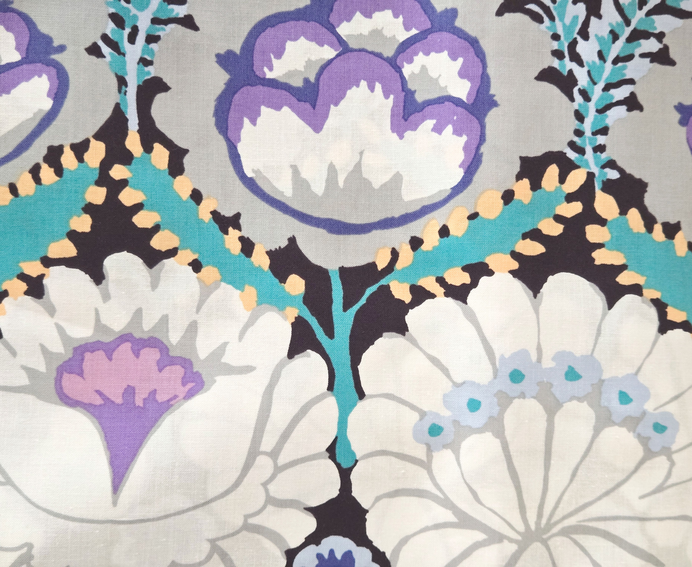 fabric features detailed, large-scale print that looks like satin stitched embroidery with large blooms on black background