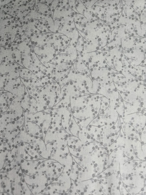 cotton fabric featuring delicate gray etchings on a crisp white background