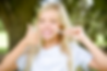girl with invisalign retainer holding thumbs up