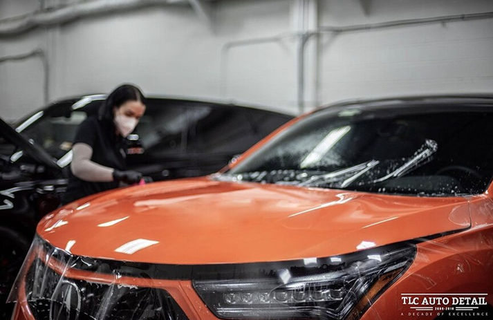 PPF Paint Protection Film being installed on an Orange Acura at TLC Auto Detail in Sterling VA