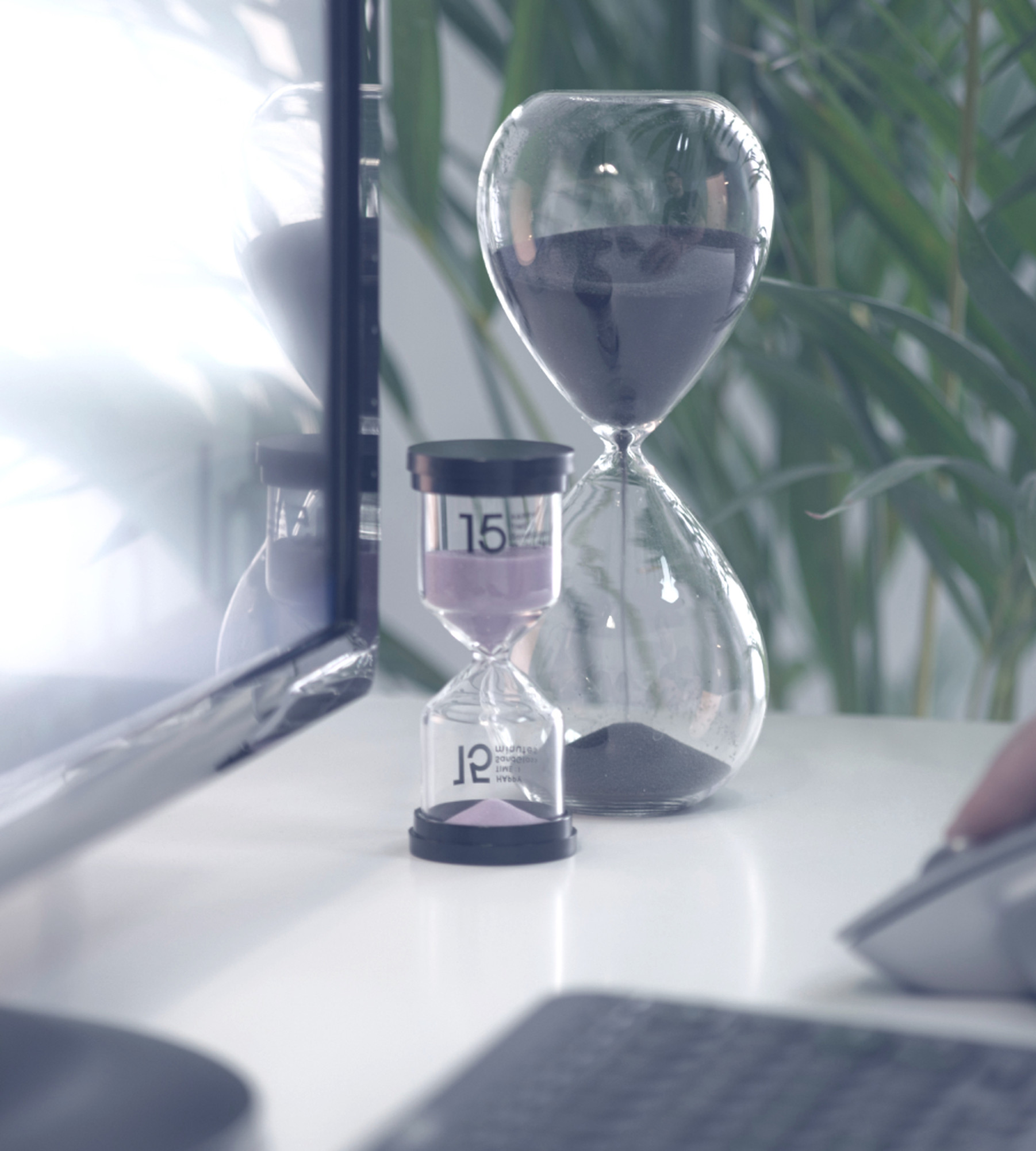 computer screen and mouse with two sand timers running out