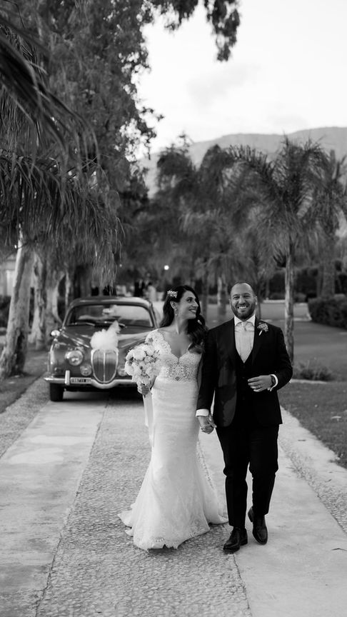 Couple dancing among guests, joyful Sicilian wedding celebration.