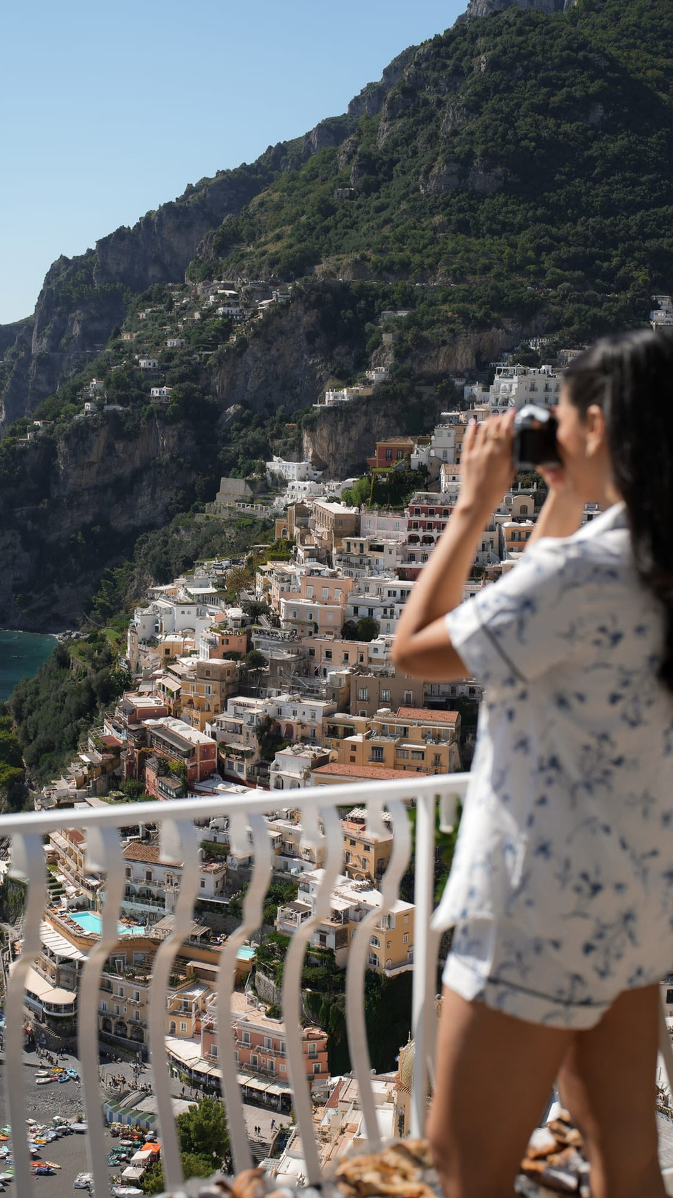 Woman enjoying drink with panoramic view of Positano, destination wedding positano.
