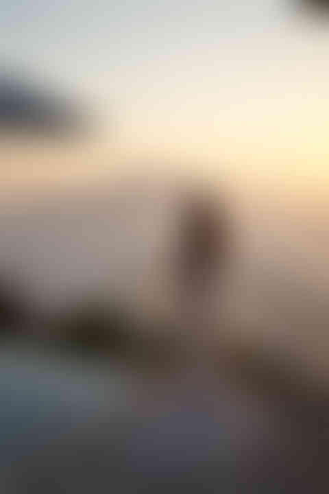 Panoramic view of the sun setting over the Gulf of Naples, serene backdrop of Aaron and April’s Amalfi Coast wedding.