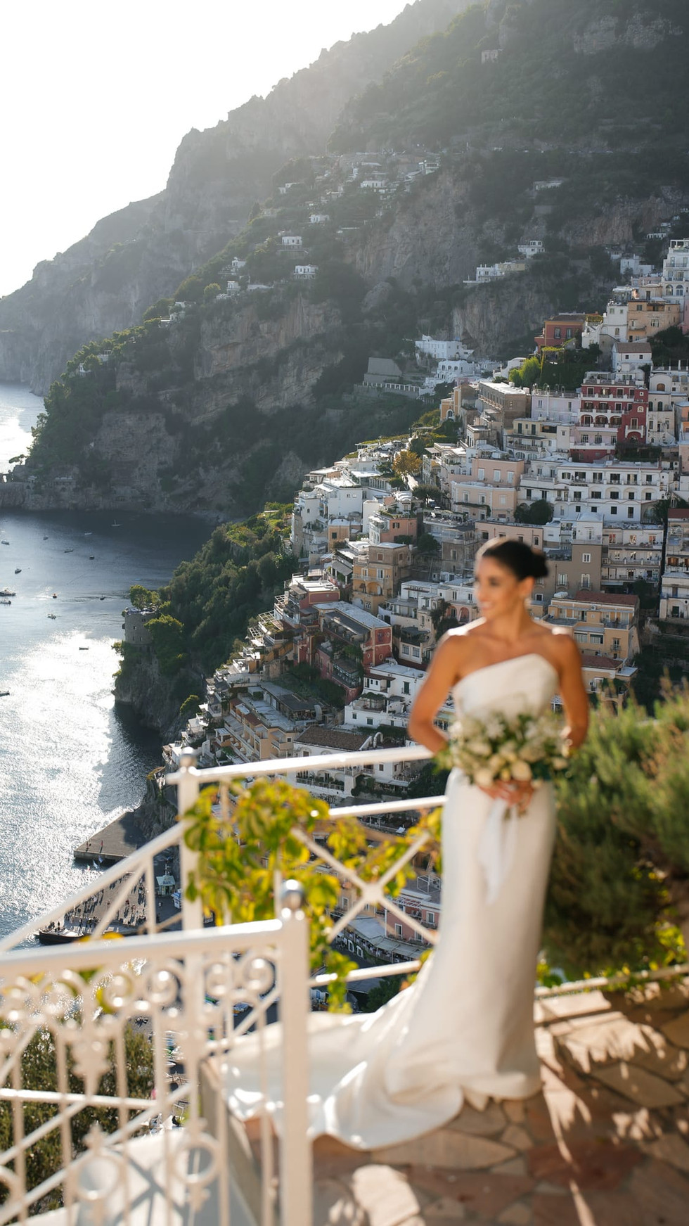 Bride in white dress overlooking Positano, Italy, destination wedding positano. Nando Spiezia