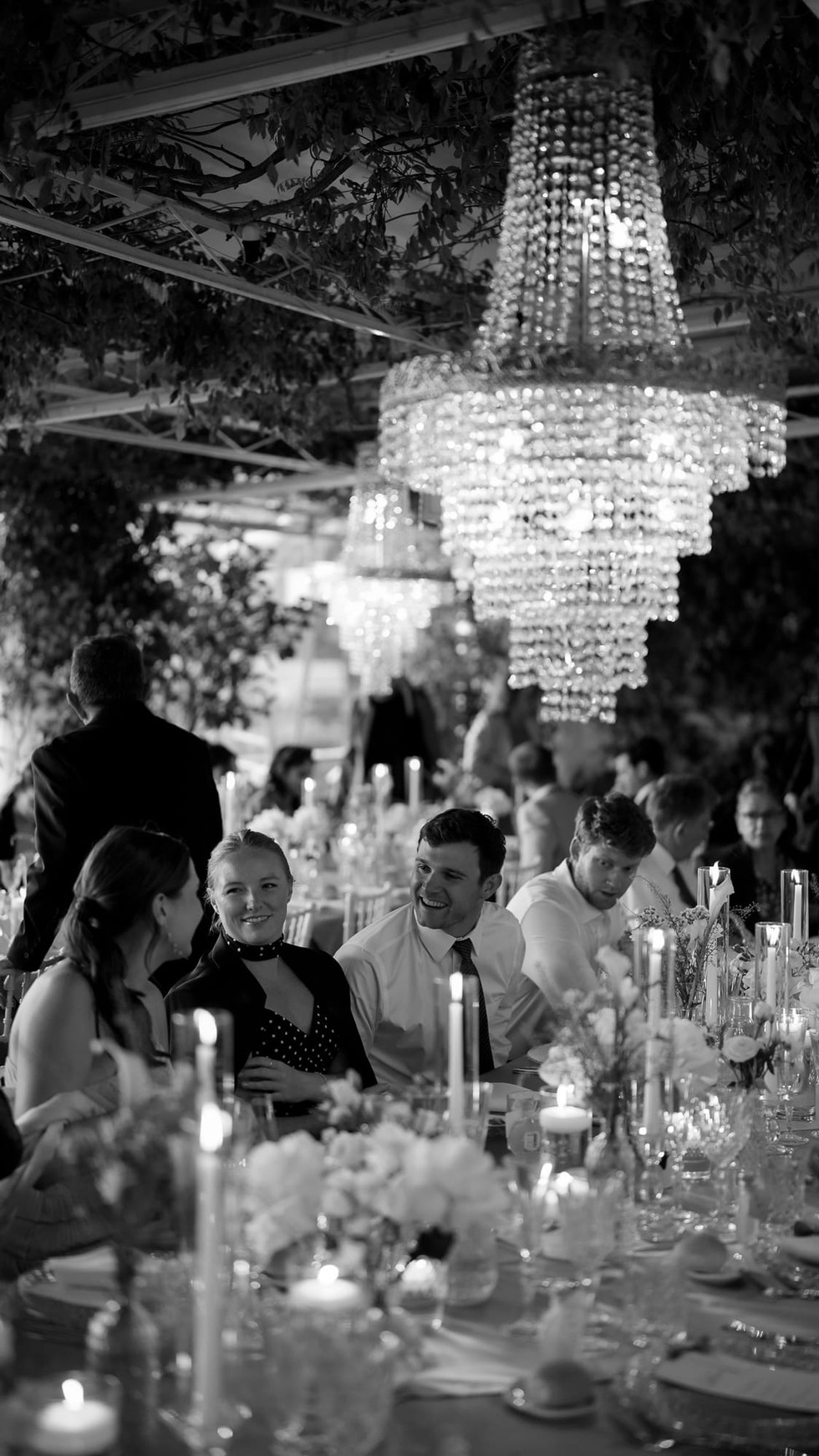 Elegant wedding reception with guests seated; large chandelier. Destination Wedding Positano • Ian and Arianna. Nando Spiezia Photography.