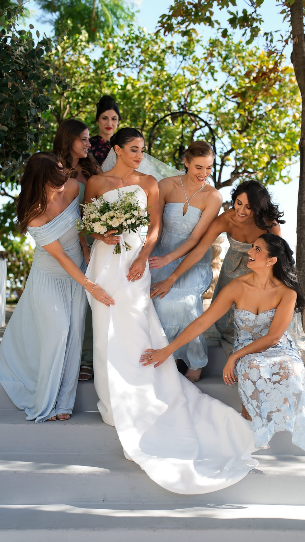 Bride with bridesmaids, Destination Wedding Positano • Ian and Arianna, smiling on steps. destination wedding positano