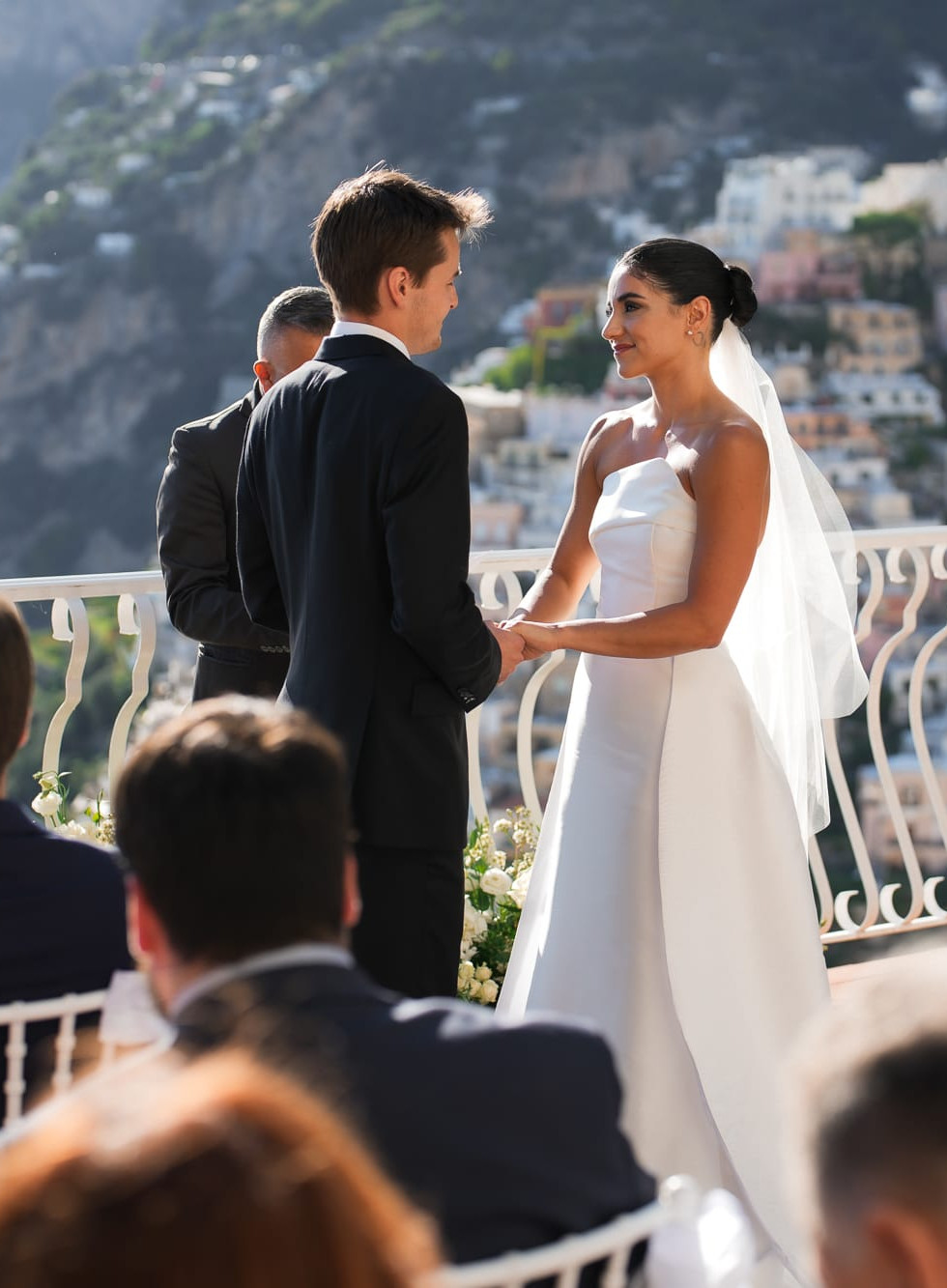 Couple exchanging vows, Destination Wedding Positano • Ian and Arianna, with stunning coastal views, destination wedding positano.