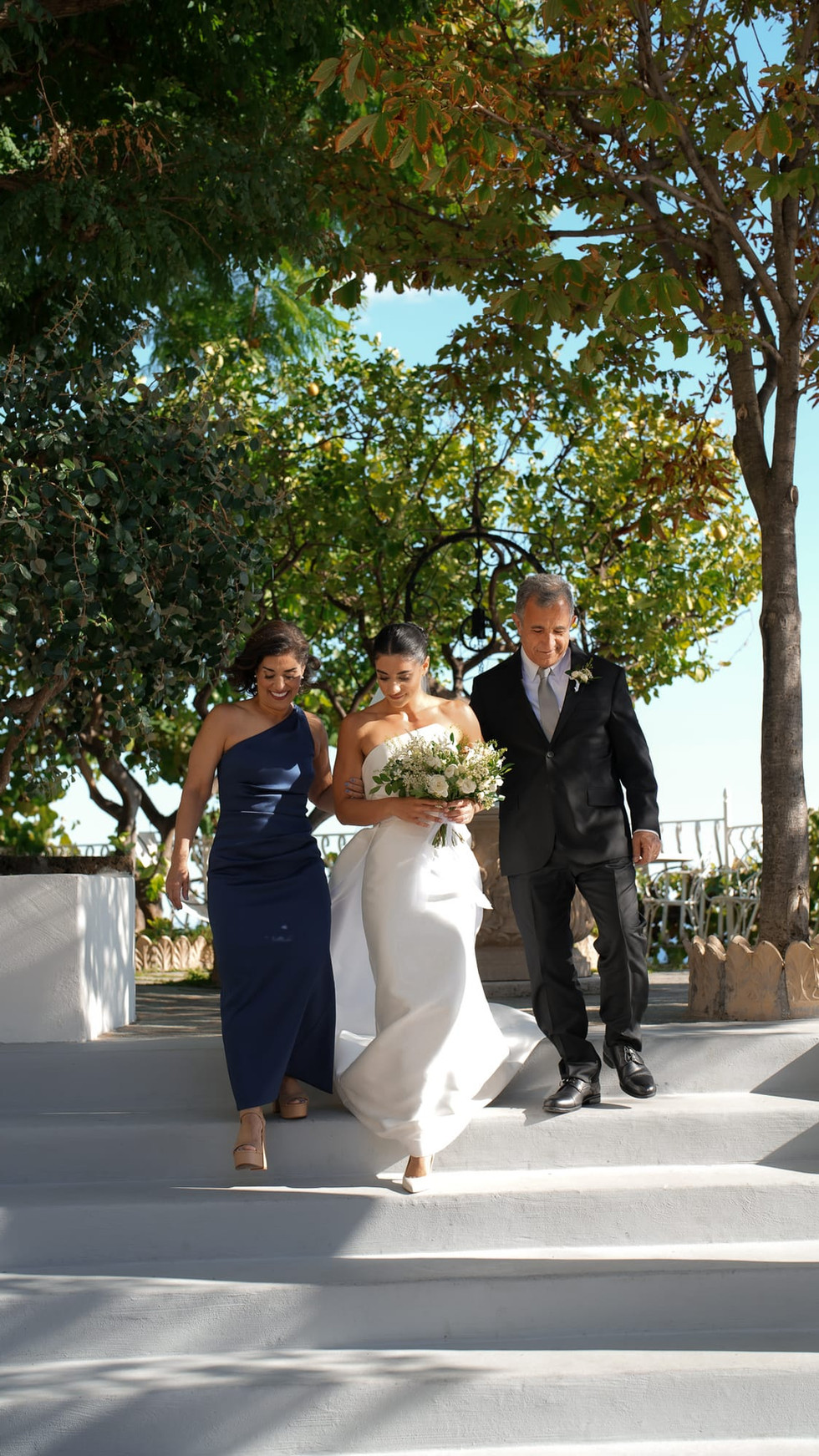 Bride walking down steps, Destination Wedding Positano • Ian and Arianna, with wedding party. destination wedding positano