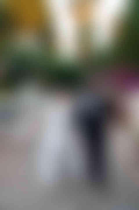 Couple walking through cobblestone streets, captured by destination wedding photographer.