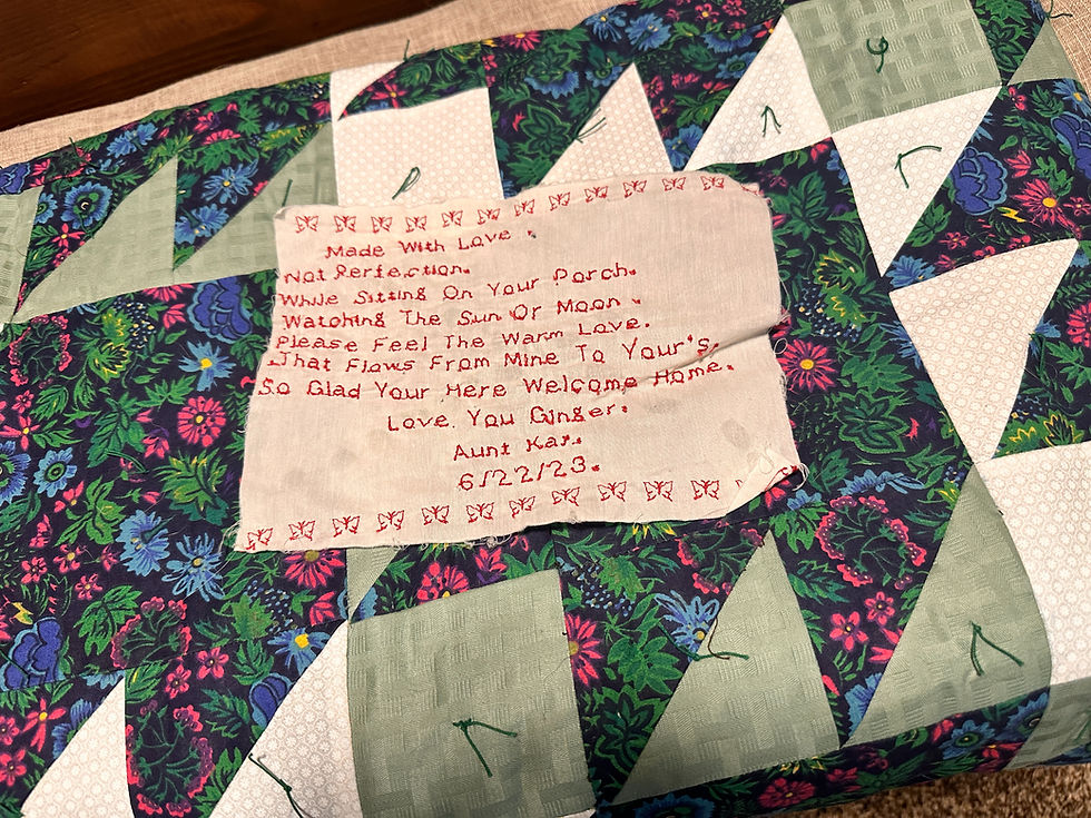 Handmade quilt with a stitched handwritten note from an aunt who made quilts for her family