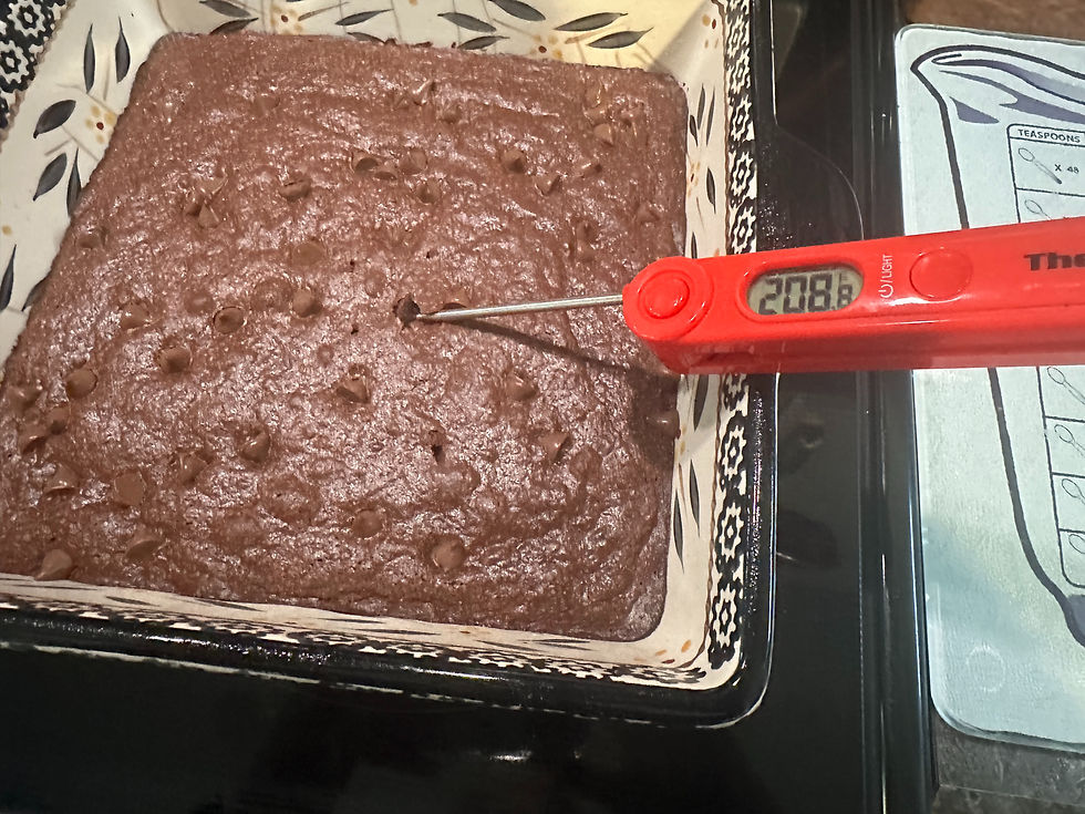 Instant read thermometer inserted into sourdough discard brownies reading 208 degrees F showing they are perfectly done