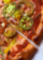 Spicy vegan pizza with marinara, cherry peppers, banana peppers, jalapeños, and vegan mozzarella.