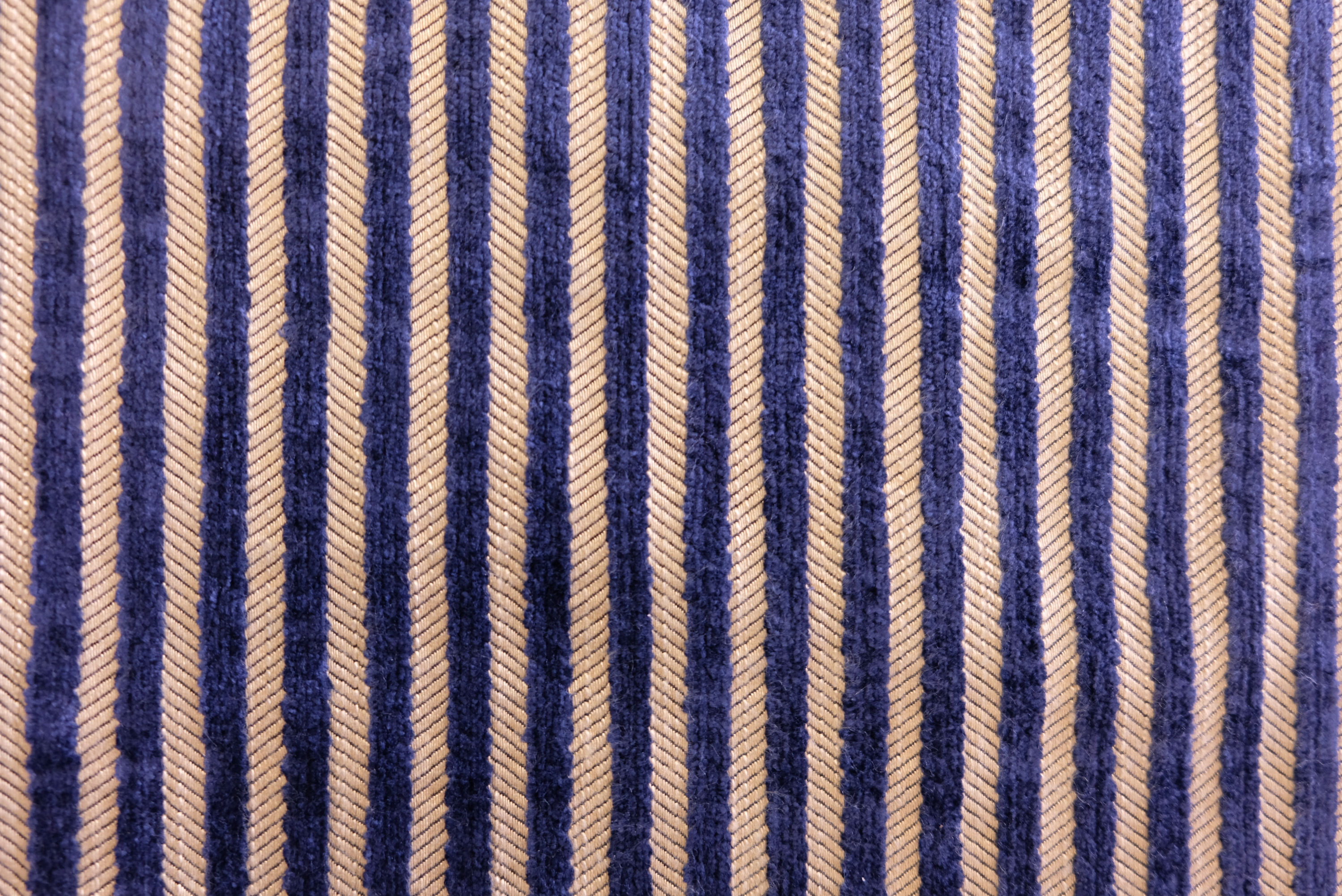 Cream cushion with a raised floral pattern and elegant fringe detailing on all sides.