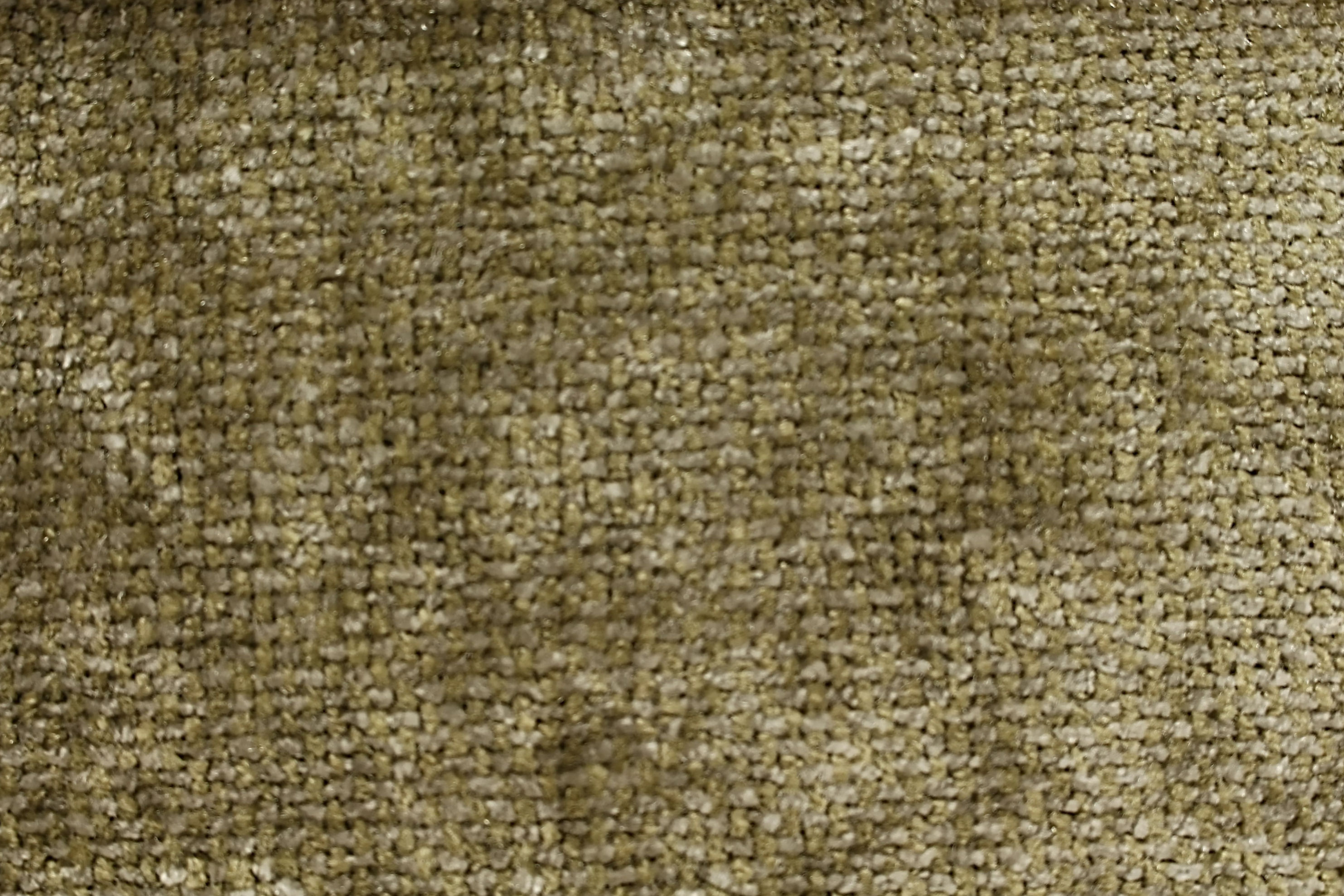 A flat view of olive-green woven fabric, displaying its intricate texture and natural sheen.