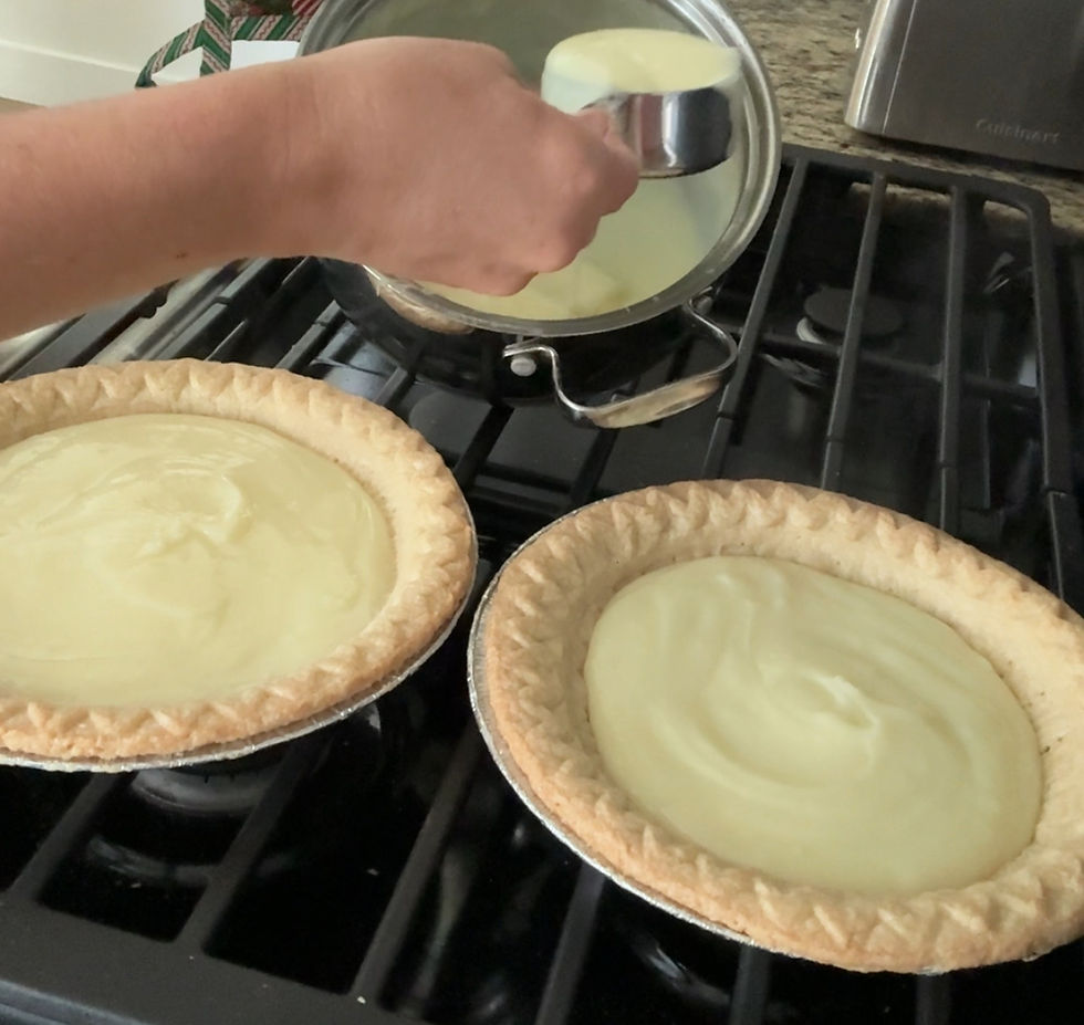 girl pouring cream pie filling into pie shells