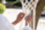 Hands of a black woman doing macrame at her garden.jpg