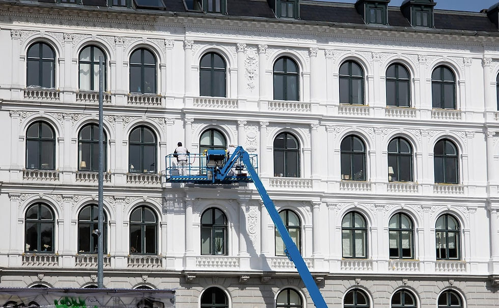 professional painter painting on large building