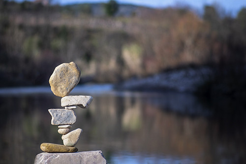 rocks balancing in front of a lake background