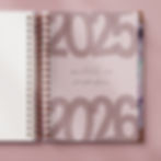 2025–2026 personalised vellum dashboard in soft pink, layered at the front of a coiled planner