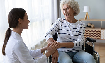 Caring female nurse caregiver hold hand