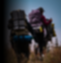 veterans hiking with backpacks and camping equipment straped on 