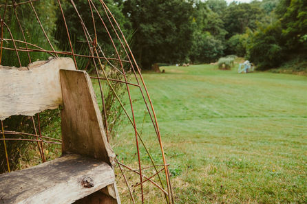 diy bench in campsite made of natural wood