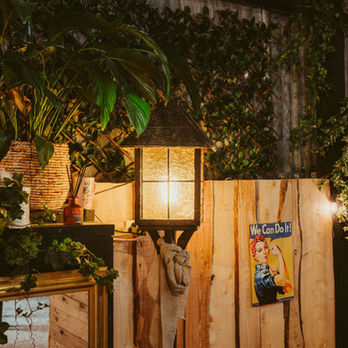 Botanical plants and warm lights decorate a cost indoor space called The Nest