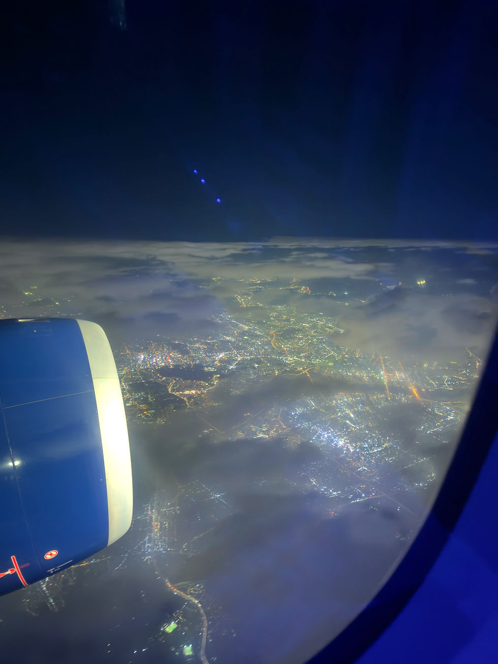 night sky and city lights from an airplane window