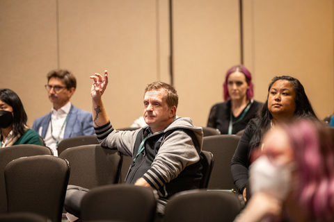 Photo of a man with his had raised