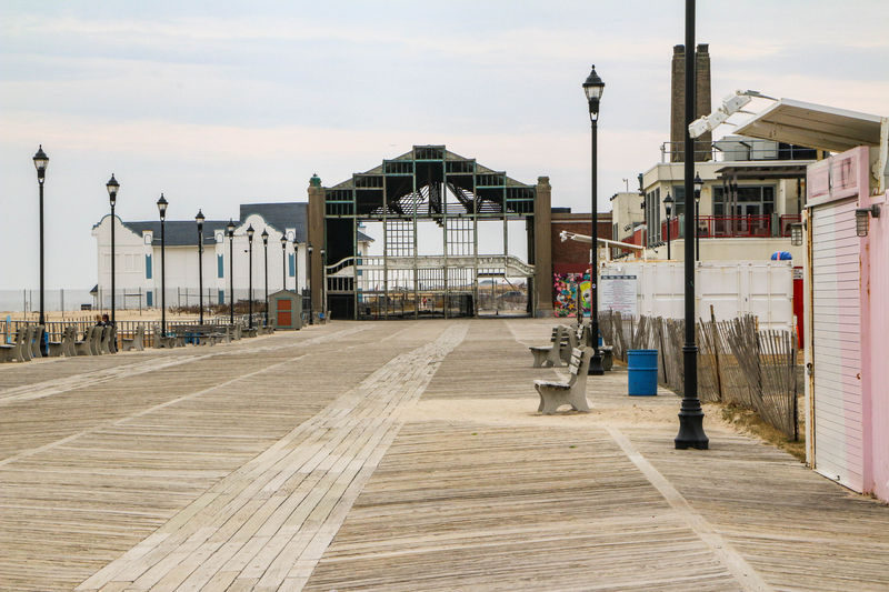 Empty wooden boardwalk leading to the deteriorating Asbury Park Casino arch before its luxury redevelopment